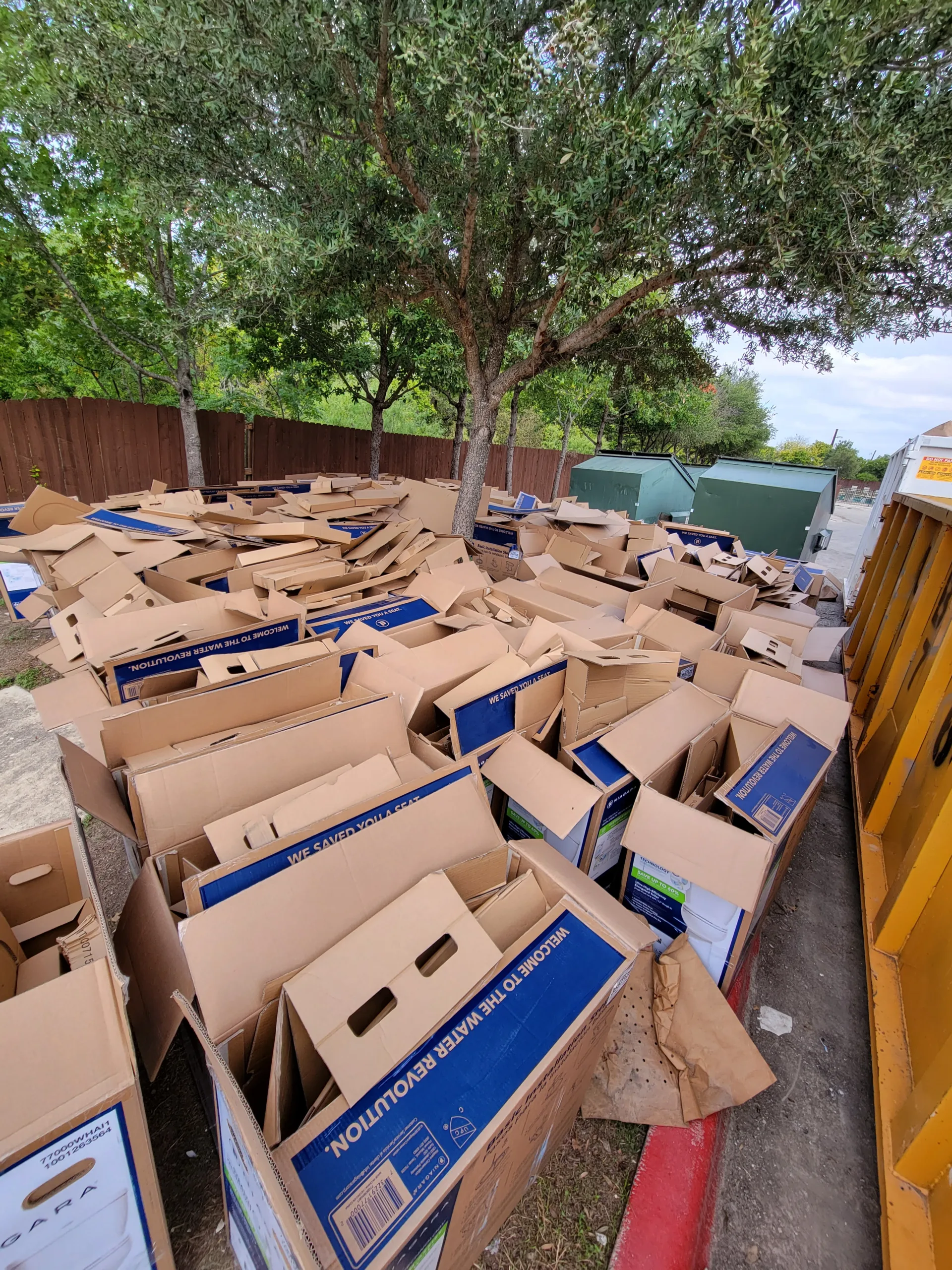 cardboard boxes from toliets sitting outside of apartment complex in Austin after doing remodleing and upgrading